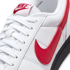 Close-up of the forefoot showing the vintage red tongue label, white laces, and the leather-and-textile upper construction.