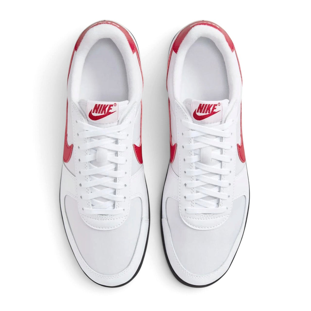 Top-down view of both sneakers placed side by side, highlighting the white textile toe boxes, white laces, and vintage red tongue logos.