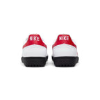 Rear view of the heels showing bold white "NIKE" lettering embroidered on vibrant red leather heel tabs