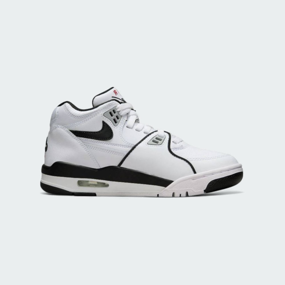 Nike Air Flight 89 Juniors' basketball trainers in white with black and red accents, side profile showing leather upper, visible Air unit in the heel, and Nike Swoosh.