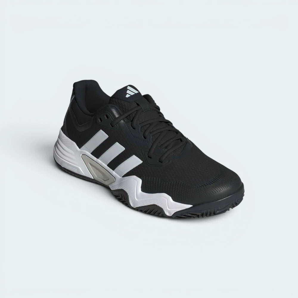 Emphasising the low-profile athletic silhouette and the professional "Core Black" colour harmony.