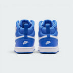 Focuses on the rear profile, highlighting the Blue Crystal leather heel cups with white embroidered "NIKE" logos, blue pull loops, and heavily padded blue mesh ankle collars.