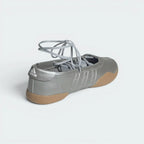 Focuses on the low-cut heel cup counter and the professional finish of the wrapping outsole edge.