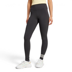 Front three-quarter view of a model wearing the black adidas Neuclassics leggings paired with white trainers, showing the high-waisted fit, full-length leg coverage, and three horizontal white stripes wrapping around the left lower shin.