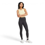 Full-length front view of the model standing with arms crossed, wearing a pastel yellow ribbed vest top, the black high-waisted adidas Neuclassics leggings, and chunky white trainers.
