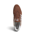 Overhead top-down view looking down at the laced brown driving shoes, displaying the matching brown flat laces, branded tongue tag with Trefoil logo, and narrow collar opening.