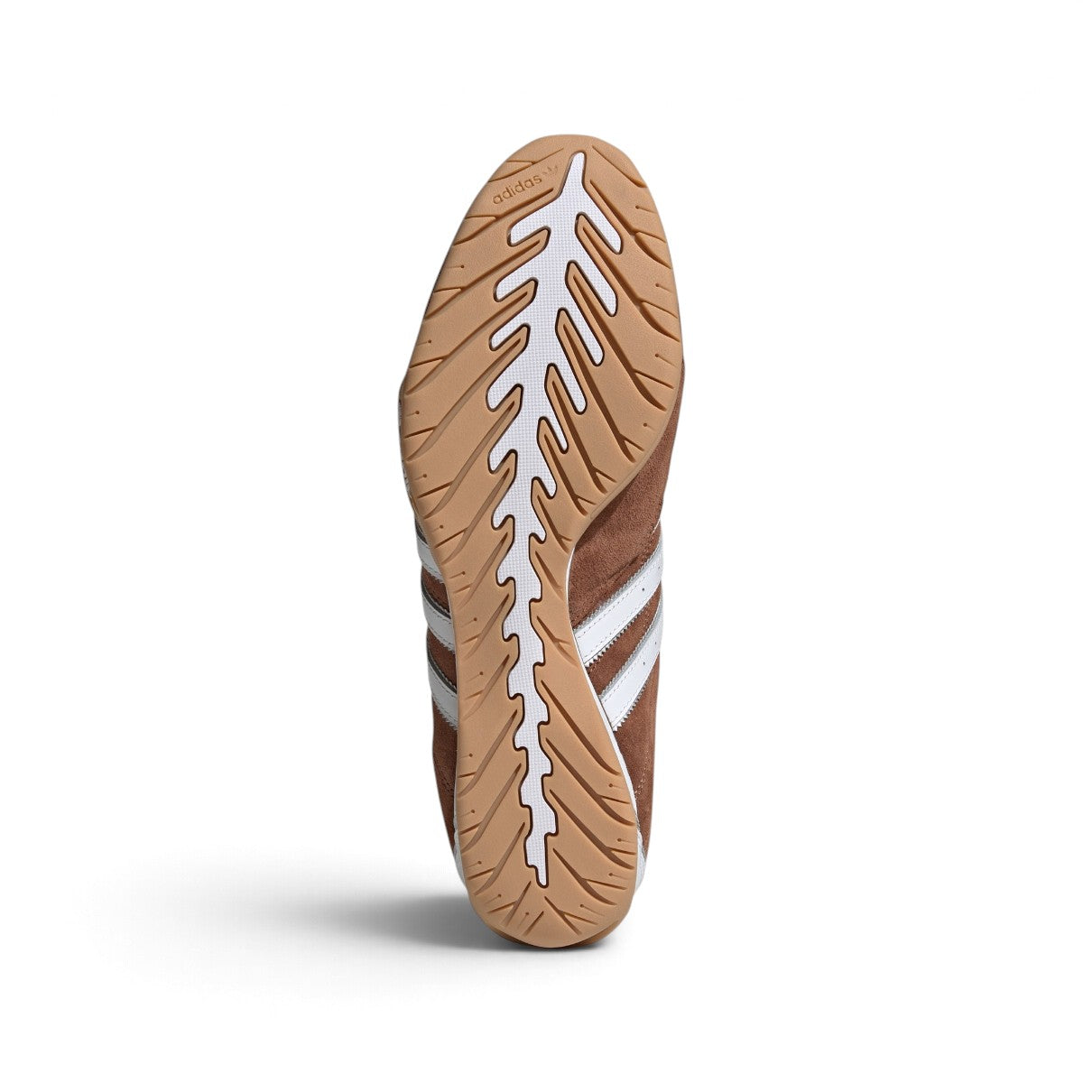 Bottom-down view of the gum rubber outsole, showcasing the organic ridged traction pattern and signature driving heel wrap.
