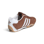 Rear-angle studio shot focusing on the white leather heel counter, metallic silver piping trim, and the curved driver's heel wrap.