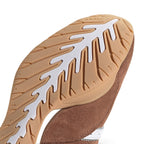 Detailed close-up angle focusing on the curved gum rubber tread pattern designed for pedal grip and natural foot flexibility.