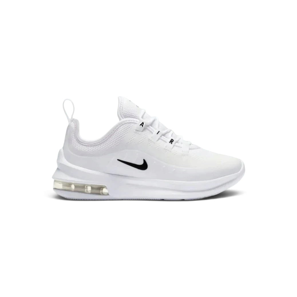 Nike Air Max Axis Children's trainers in white with black accents, side profile showing layered mesh and synthetic upper, prominent visible Max Air unit in the heel, and Nike Swoosh.