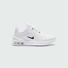 Nike Air Max Axis Children's trainers in white with black accents, side profile showing layered mesh and synthetic upper, prominent visible Max Air unit in the heel, and Nike Swoosh.