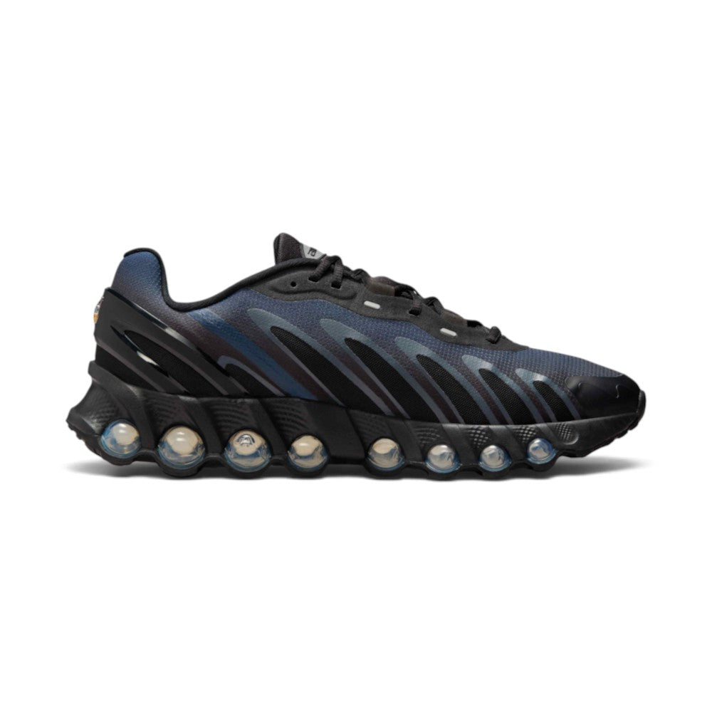 Highlights the inner profile displaying the sweeping Wolf Grey flame overlays over Thunder Blue gradient mesh, seamless toe cap, and the inner row of visible blue Dynamic Air cushioning tubes.