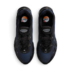 Focuses on the locked-in central lacing layout, displaying flat black laces, black mesh tongues topped with oval metallic "AIRMAX" badges, reflective lace loop accents, and black insoles printed with circular orange-and-white Air Max branding.