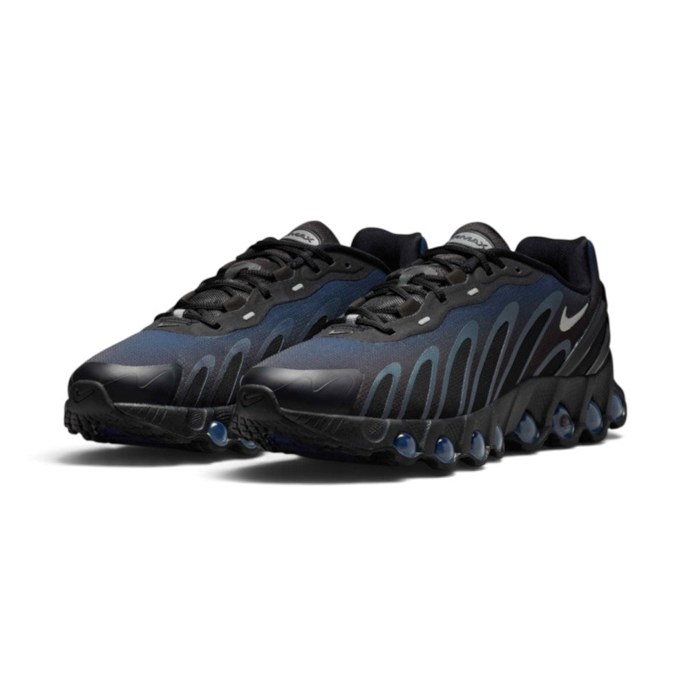 Emphasising the aggressive, low-profile stance of the trainers and the luminous gradient contrast between the deep Thunder Blue underlays, grey sculpted cage lines, and transparent blue Dynamic Air pods.