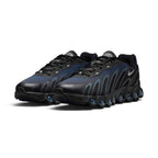 Emphasising the aggressive, low-profile stance of the trainers and the luminous gradient contrast between the deep Thunder Blue underlays, grey sculpted cage lines, and transparent blue Dynamic Air pods.