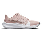 Displays the full lateral silhouette featuring the soft Pink Oxford mesh upper, the striking layered metallic Swoosh design, the thick white React foam midsole with embedded Air Zoom branding, and the textured outsole edge.