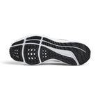 Full-length bottom profile showing the waffle-inspired rubber outsole, highlighting the strategic traction pods, flex grooves designed for smooth heel-to-toe transition, and carved arch channels.