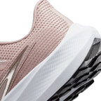 Macro view of the lateral heel transition, highlighting the fine geometric texture moulded into the React foam midsole sidewall and the clean integration into the rubber outsole tread.
