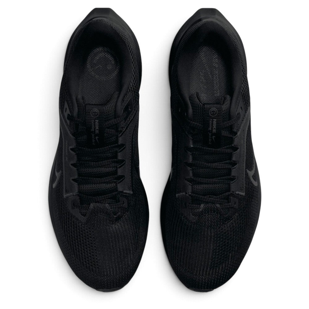 Direct overhead view of both shoes, displaying the streamlined breathable mesh toe boxes, central lacing system with flat black laces, padded tongue with circular Nike Pegasus running badges, and dark cushioned footbeds.