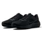 Forward three-quarter angle showcasing both shoes side by side, highlighting the aerodynamic road running stance, reinforced toe tips with "EST. 1972" embossed lettering, and stealth blackout styling.