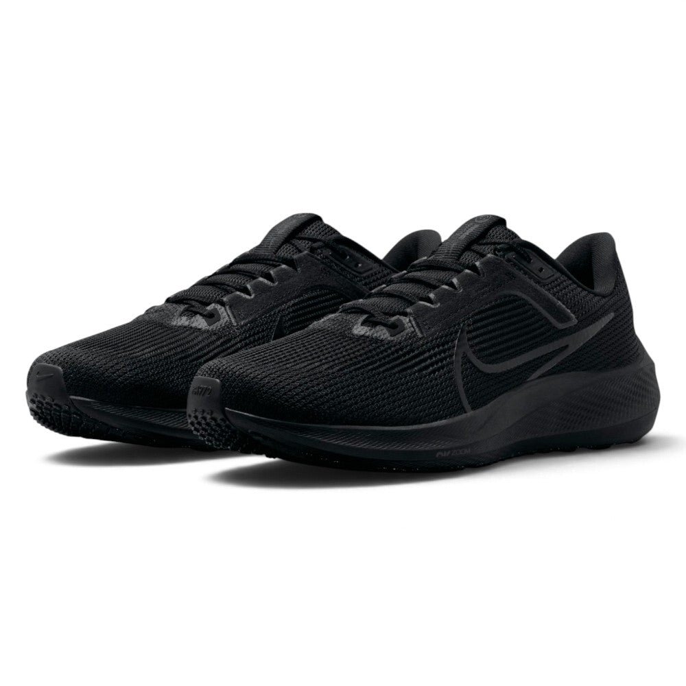 Forward three-quarter angle showcasing both shoes side by side, highlighting the aerodynamic road running stance, reinforced toe tips with "EST. 1972" embossed lettering, and stealth blackout styling.