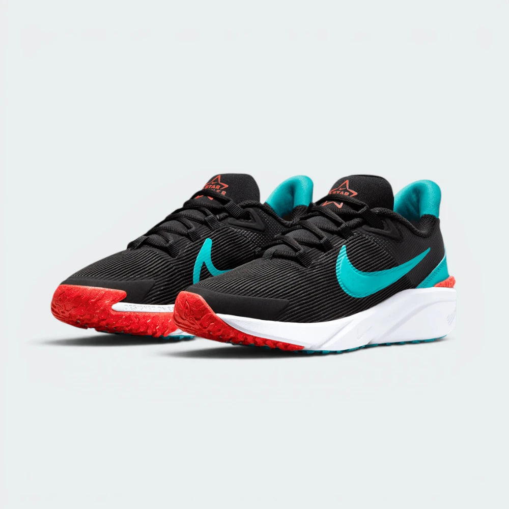 Emphasising the low-cut, athletic running stance of the youth shoes, highlighting the sport harmony of the bright crimson and teal contrast accents.