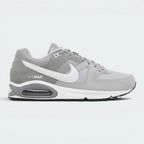 Highlights the high-velocity sweep of the contrasting white Nike Swoosh, showing the professional, multi-textured grey mesh underlays, the clean Stealth grey overlays, and the prominent visible Max Air window embedded in the heel of the foam midsole.