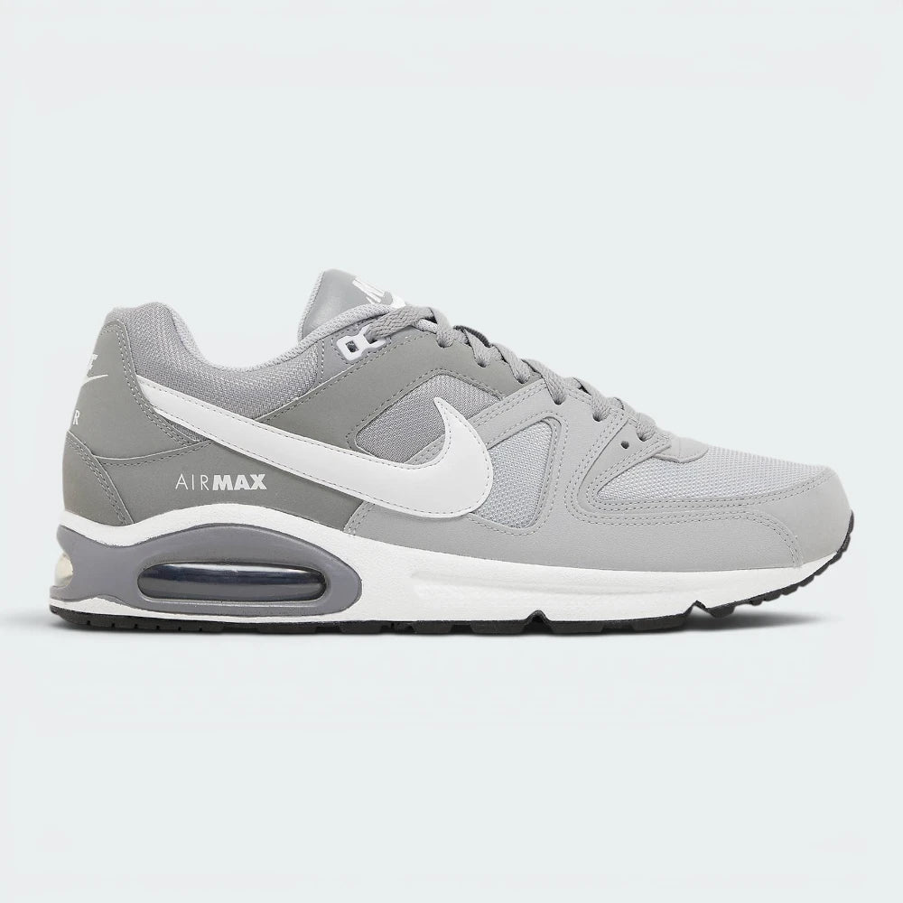 Highlights the high-velocity sweep of the contrasting white Nike Swoosh, showing the professional, multi-textured grey mesh underlays, the clean Stealth grey overlays, and the prominent visible Max Air window embedded in the heel of the foam midsole.