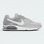 Highlights the high-velocity sweep of the contrasting white Nike Swoosh, showing the professional, multi-textured grey mesh underlays, the clean Stealth grey overlays, and the prominent visible Max Air window embedded in the heel of the foam midsole.