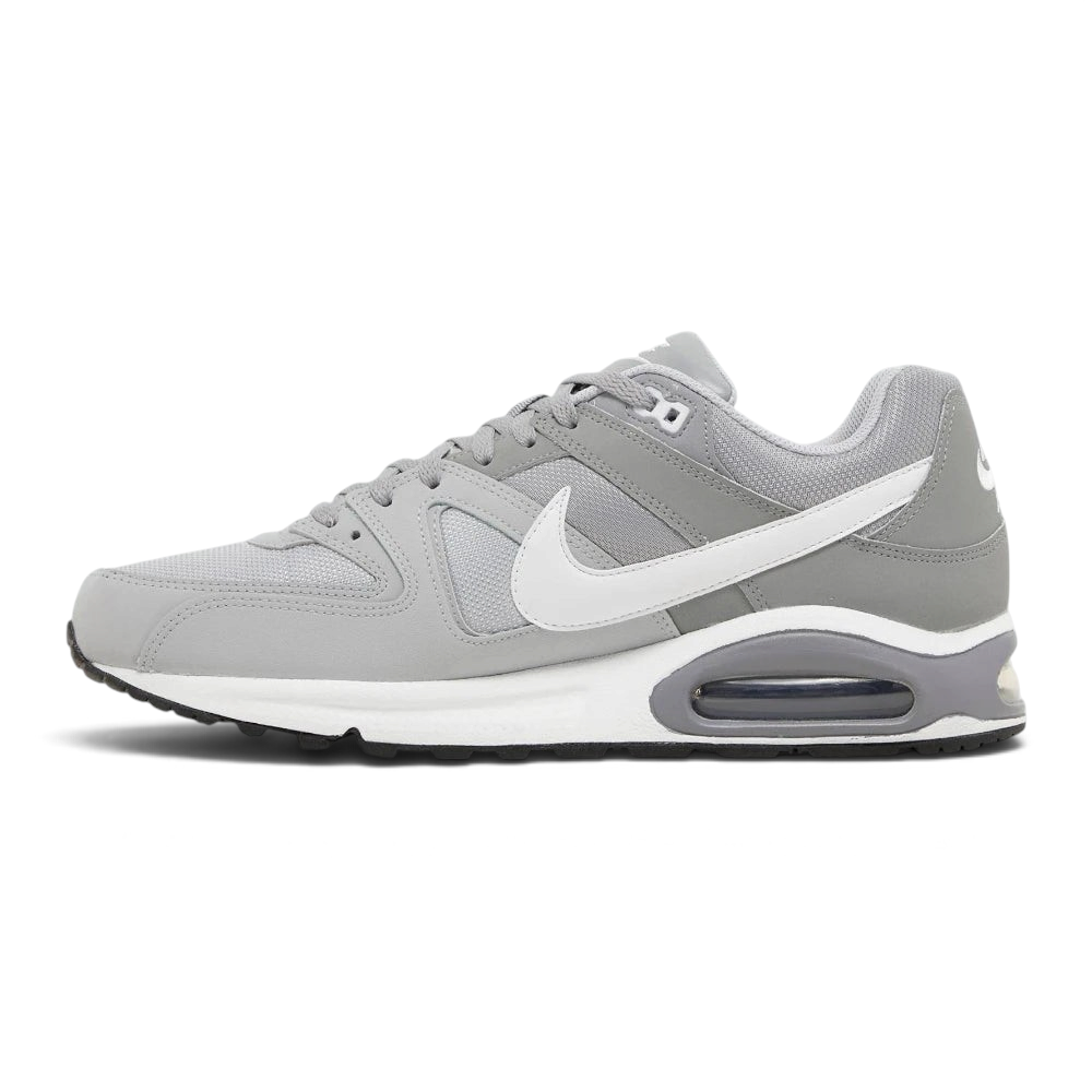 A Nike Air Max sneaker in gray and white, shown from a side profile view against a light gray background.