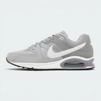 A Nike Air Max sneaker in gray and white, shown from a side profile view against a light gray background.