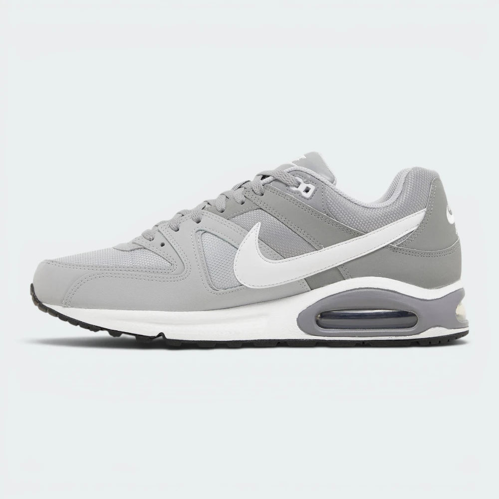 A Nike Air Max sneaker in gray and white, shown from a side profile view against a light gray background.