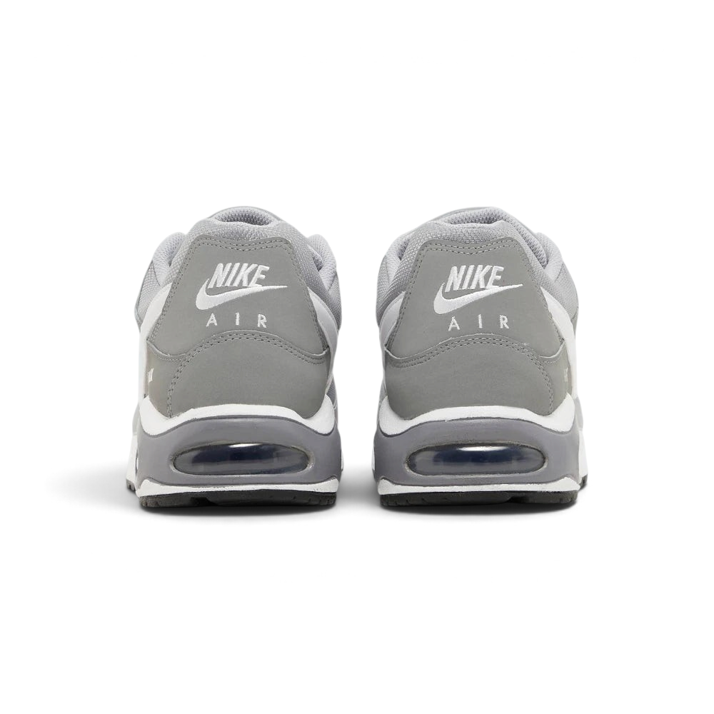 Focuses on the contoured shape of the padded low-cut collar, highlighting the embroidered Nike Air logo on the heel tab sitting squarely above the robust heel frame and the translucent Air window.