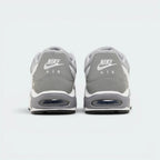 Focuses on the contoured shape of the padded low-cut collar, highlighting the embroidered Nike Air logo on the heel tab sitting squarely above the robust heel frame and the translucent Air window.