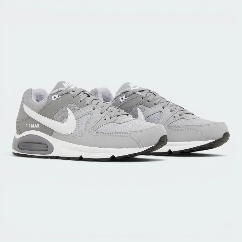 Emphasising the classic, bulky athletic stance of the trainers and the professional harmony of the layered grey and charcoal paneling.