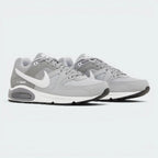 Emphasising the classic, bulky athletic stance of the trainers and the professional harmony of the layered grey and charcoal paneling.