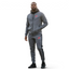 Nike Air NSW Fleece Men's Tracksuit in heather grey, front view worn by a model showing the full-zip hoodie and matching tapered joggers, with Nike Air logos visible.