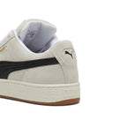 Close-up rear angle focusing on the Sand suede heel counter, embroidered black PUMA Cat logo, plush white collar lining, and debossed PUMA branding on the chunky off-white midsole bumper.