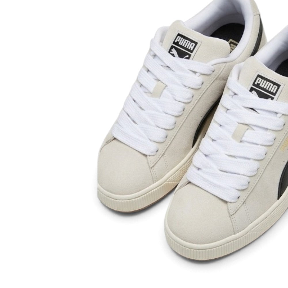 Details the micro-precision of the forefoot area from an elevated angle, showing the soft Sand suede toe boxes, chunky woven white fat laces, and padded tongue crests.
