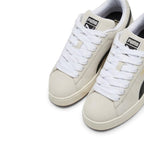 Details the micro-precision of the forefoot area from an elevated angle, showing the soft Sand suede toe boxes, chunky woven white fat laces, and padded tongue crests.