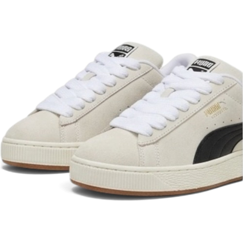 Details the micro-precision of the forefoot area from an elevated angle, showing the soft Sand suede toe boxes, chunky woven white fat laces, and padded tongue crests.