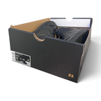 A pair of black Jordan sneakers inside an open black Air Jordan shoebox, photographed on a light gray background.