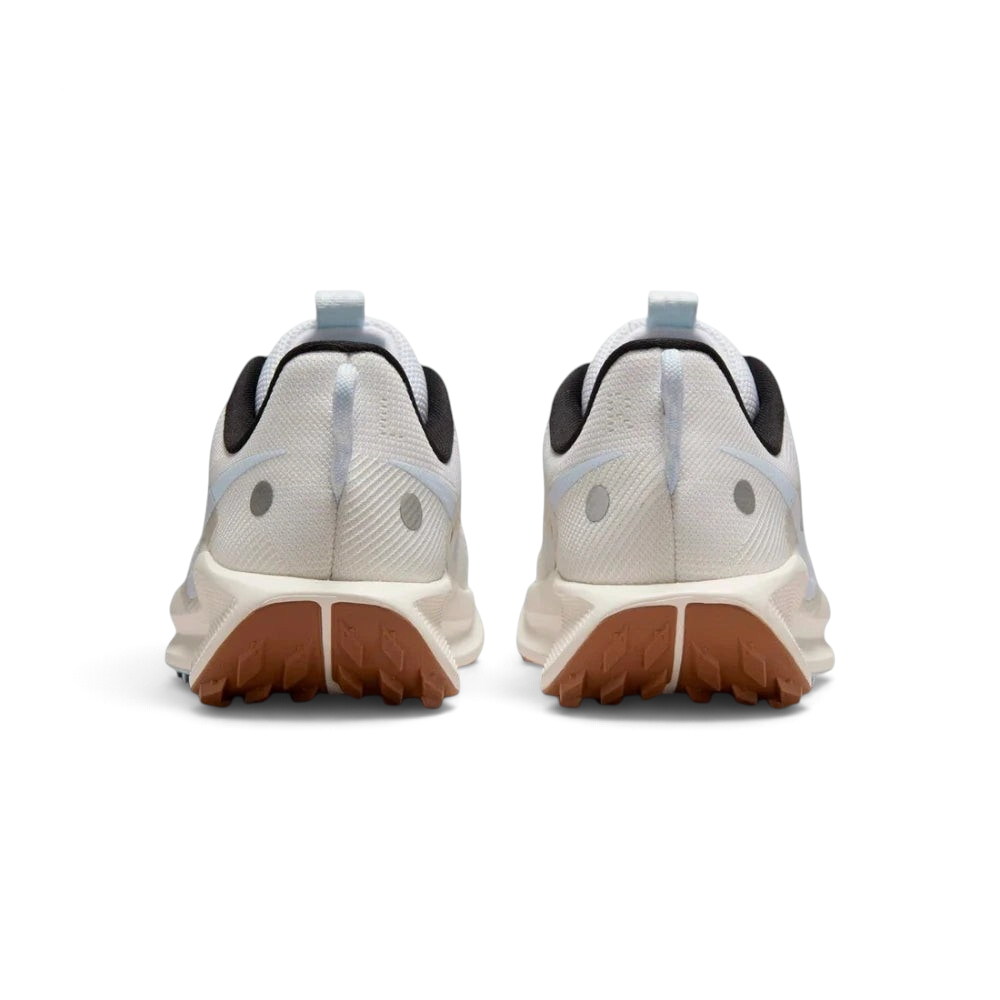 Trade Sports Nike Women's ReactX Pegasus Trail 5 in white and blue with a brown all-terrain rubber outsole, rear view.