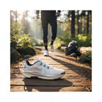 Trade Sports Nike Women's ReactX Pegasus Trail 5 in white and blue on a forest trail with a runner in the background