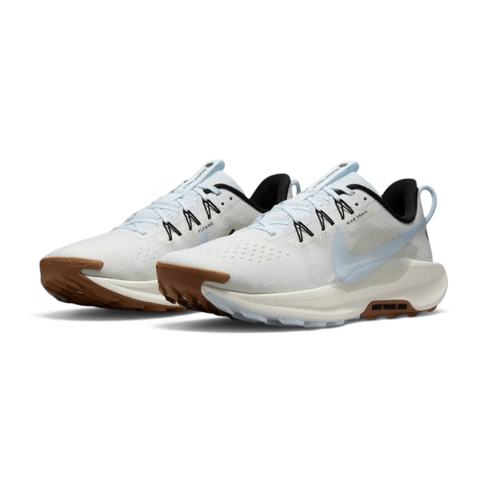 Trade Sports Nike ReactX Pegasus Trail 5 women's running shoes in white and blue with a brown all-terrain outsole.