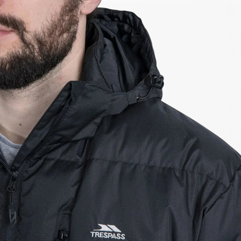 Trade Sports Trespass Clip black padded jacket with adjustable hood and zip closure worn by a man
