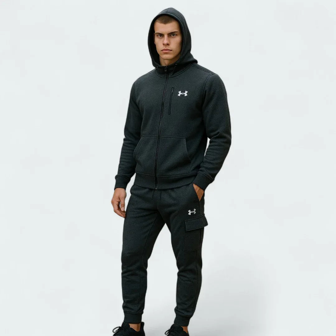 Under Armour Men's Fleece Cargo Tracksuit in black, front view on a model showing the hooded top with a kangaroo pocket and matching cargo joggers. Main image