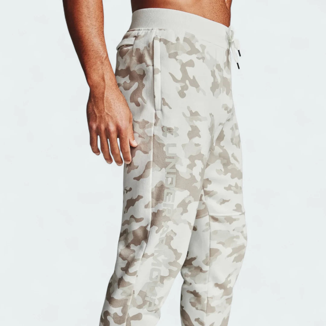 Under Armour Rival Fleece Camo Track Pants Men's in onyx white, side profile showing the full length, tapered leg, and camouflage pattern.