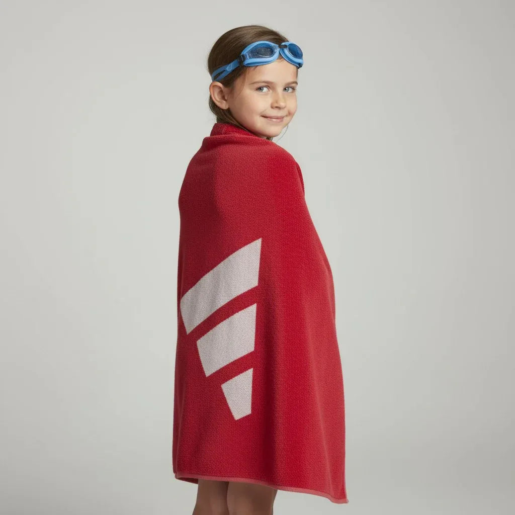 child using the towel to dry up after swimming
