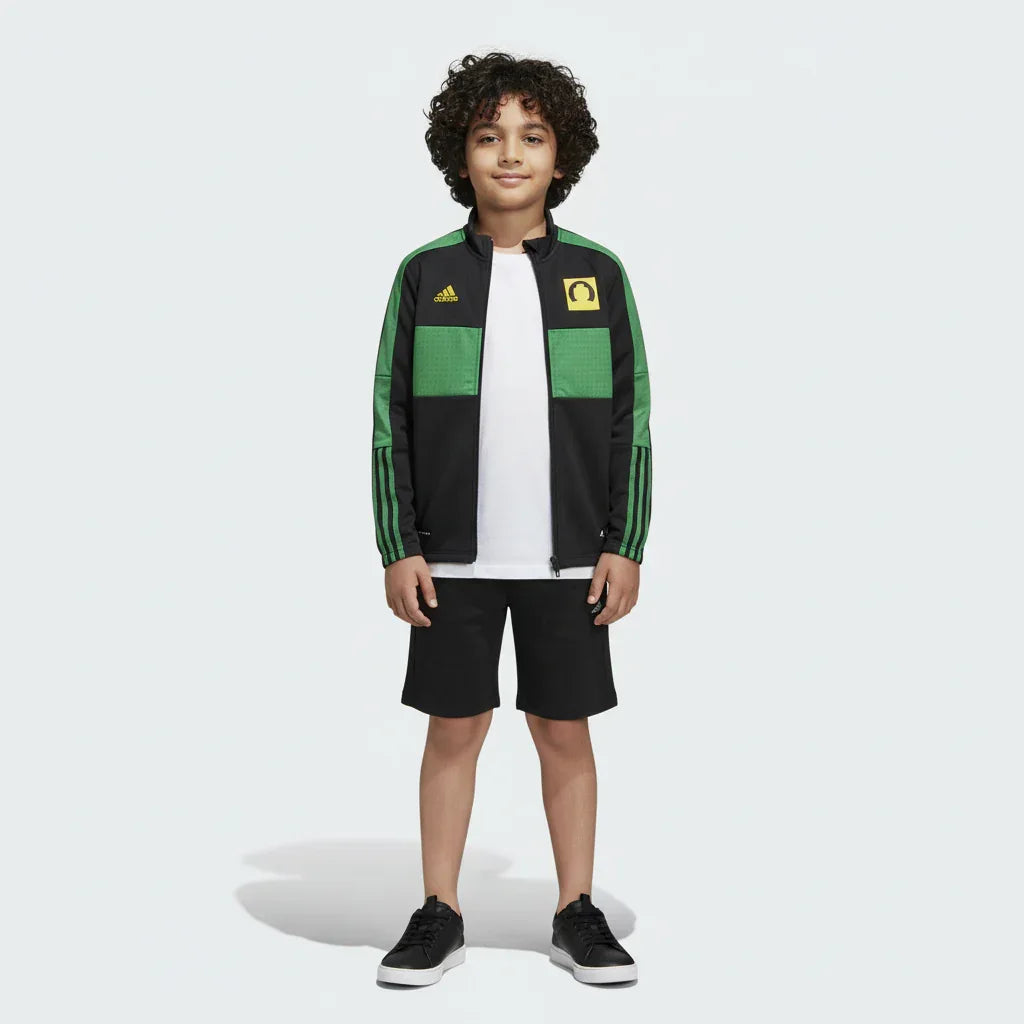 Child wearing a green and black Adidas tracksuit on a white background Main image